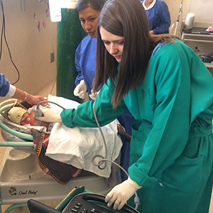 Mary Crocker, M.D., uses an ultrasound to detect an infant’s lung infection for her Fogarty Fellowship research. (Photo courtesy of Mary Crocker).